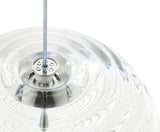 Close-up of transparent glass pendant light with metal cable fixture on white background