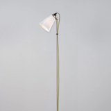 Floor lamp with a white shade on a gray background