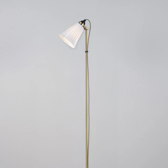 Floor lamp with a white shade on a gray background